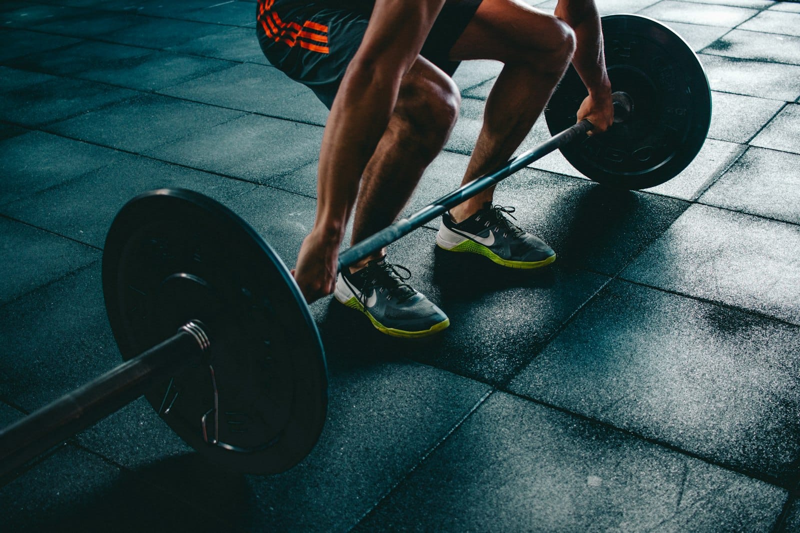 Man sitting on gym bench looking exhausted